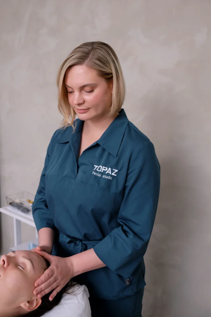 Hands performing lifting and sculpting facial massage