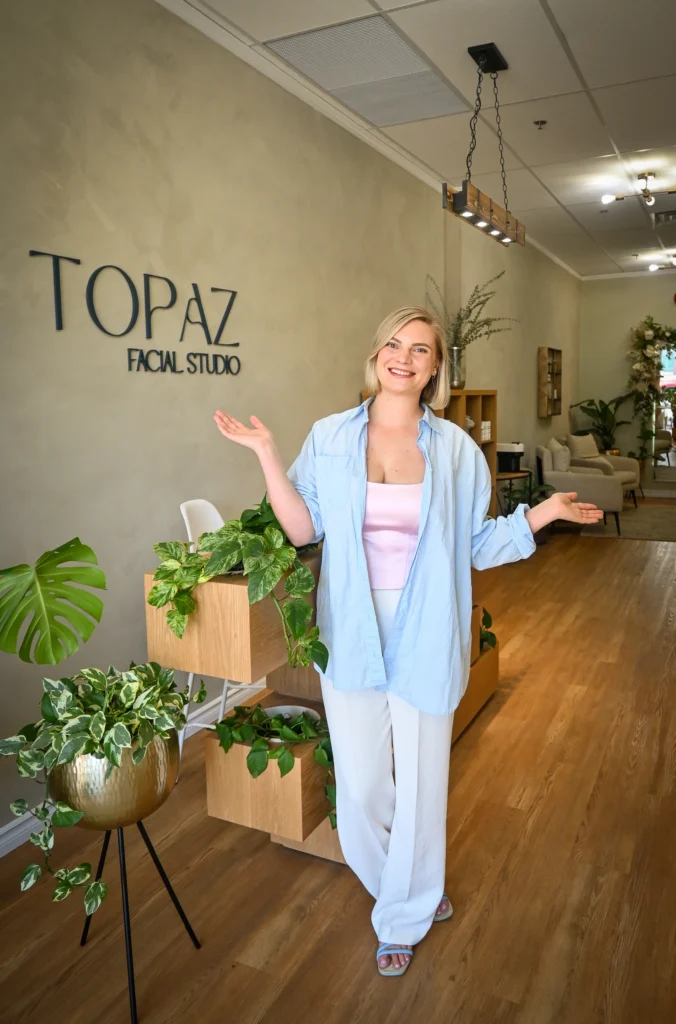 Topaz Facial Studio staff member welcoming visitors inside the studio.