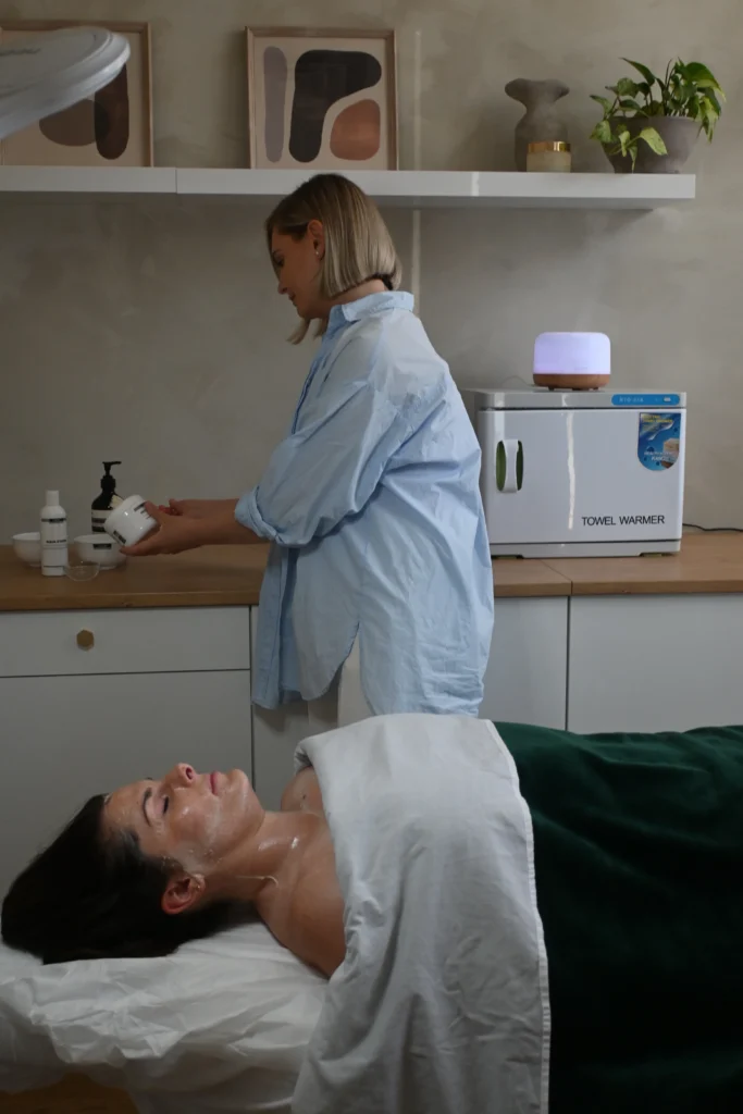 Topaz practitioner preparing a treatment room for a client.