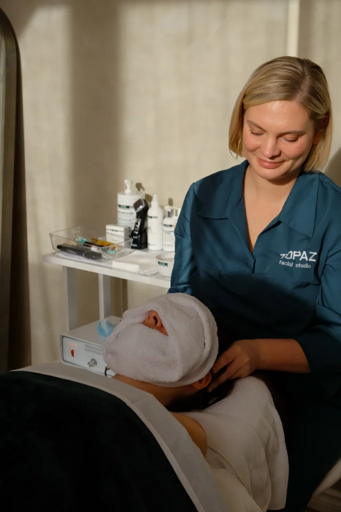 Anna Koshevaia providing personalized facial care to a client