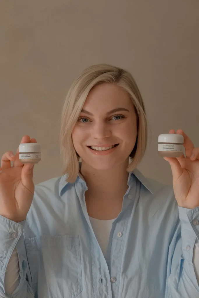 Skincare professional holding two treatment products.