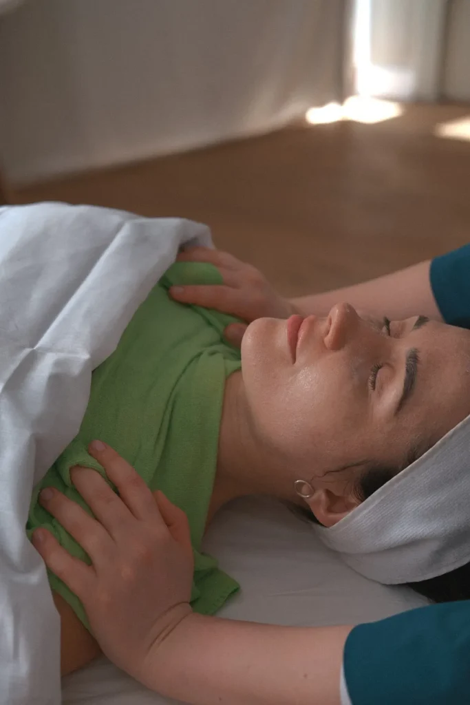 Topaz practitioner using a hands-on facial and décolletage massage technique.
