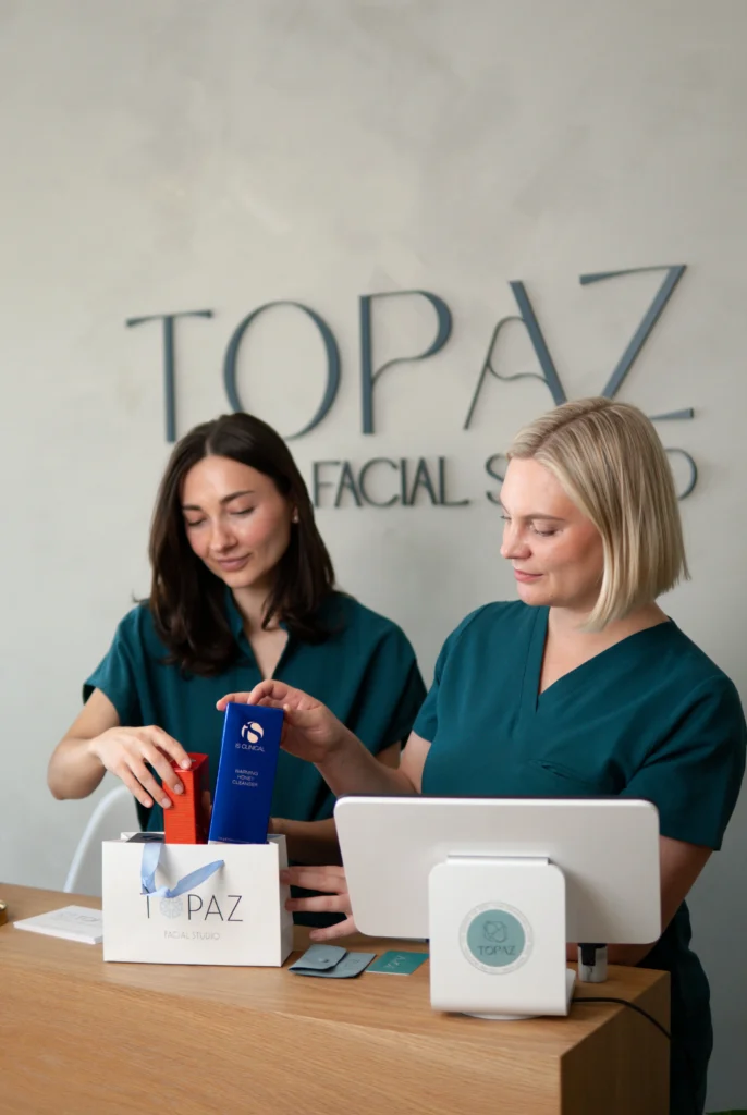 Elena and Anna reviewing skincare products at the studio.
